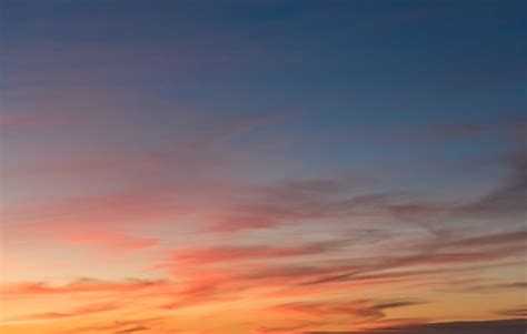 Free Photo | Beautiful shot of pink clouds in a clear blue sky with a scenery of sunrise