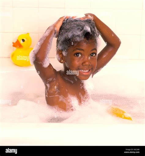 Young African American girl taking a bubble bath with her hands Stock Photo: 246379 - Alamy