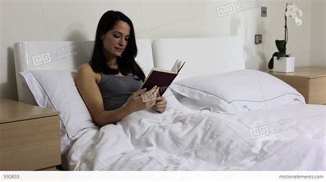 Young Woman Reading In Bed Stock video footage | 930833