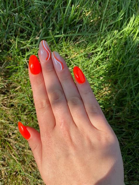 Bright Orange Nails With White Swirls Design Idea – Vibrant Guide
