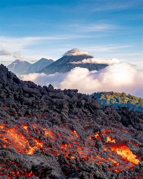 Lava flow from the Pacaya volcano, with Agua, Acatenango and Fuego volcanoes in the background ...