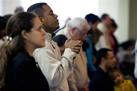 The congregation pray during a Sunday service at Congregacion Leon de... | Congregation ...