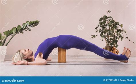 Woman Practicing Yoga, Doing Seto Bandha Sarvangasana Exercise with ...