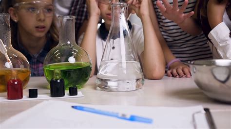 Scientist working with chemical reaction in chemistry lab while young ...