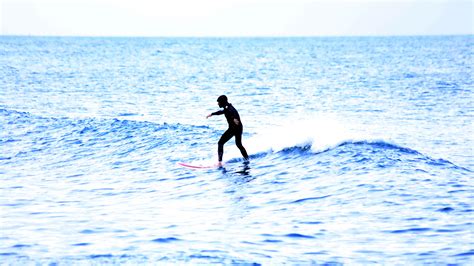 Winter surfing on the beach of San Sebastian (Platja de Sant Sebastià ...