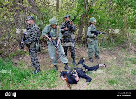 US soldiers stand over a dead Viet Cong soldier in a reenactment of Stock Photo, Royalty Free ...