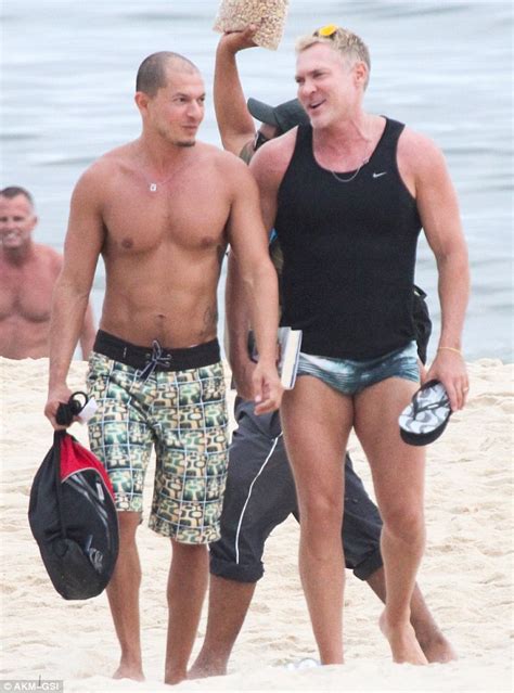 Sam Champion, 52, flaunts his buff body on Brazilian beach alongside his artist husband | Daily ...