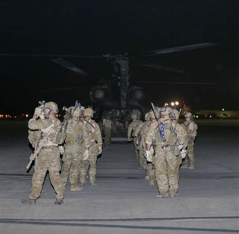 Rangers of 3rd Battalion, 75th Ranger Regiment, board their aircraft to go into the night and ...