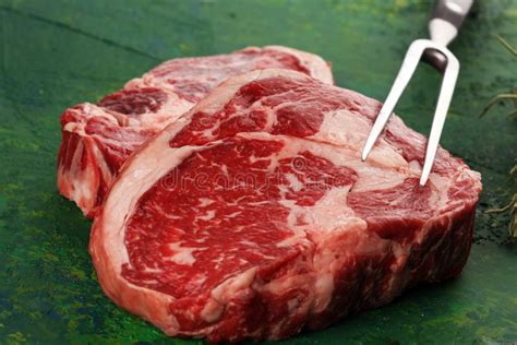 Steak. Two Fresh Raw Rib-eye Steak with Rosmary in a Rustic Style Table Stock Photo - Image of ...