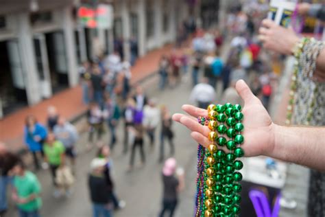 Mardi Gras Beads In Hand Above Bourbon Street Stock Photo - Download Image Now - iStock