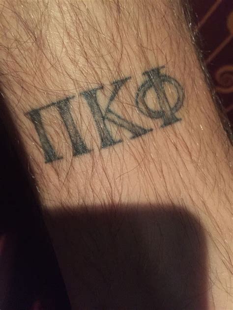 a close up of a person's wrist with the word tiko on it