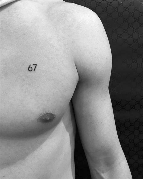 Number 67 tattoo on the chest.