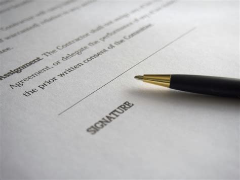 Person Signing in Documentation Paper · Free Stock Photo