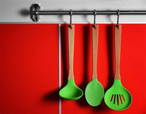 Premium Photo | Set of wooden kitchen utensils hanging on wall