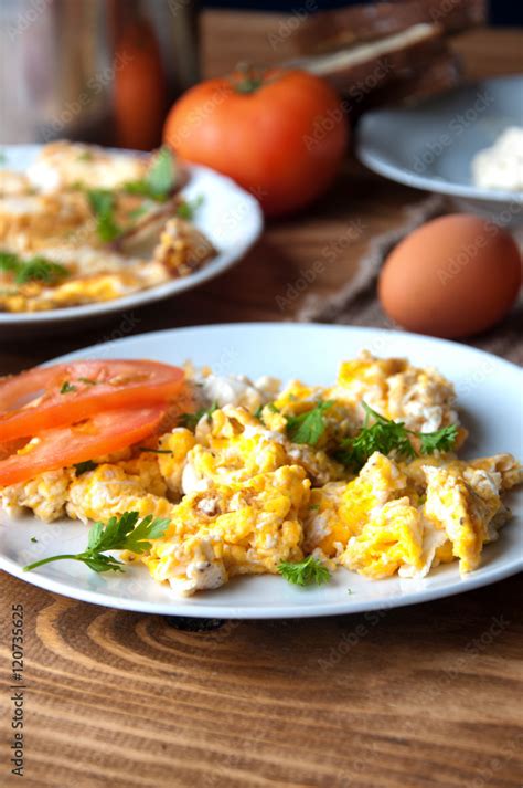 Scrambled, fried, boiled eggs on a wooden table Stock Photo | Adobe Stock