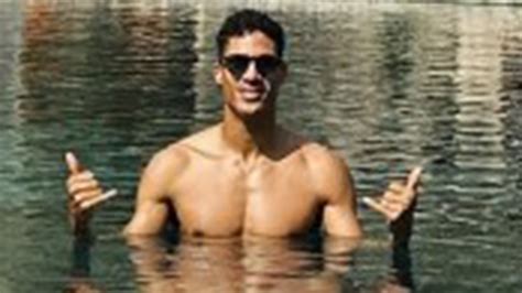 Raphael Varane relaxes with stunning wife on the beach as Man Utd ...