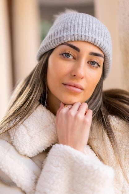 Premium Photo | Caucasian woman with wool cap in a city park looking at camera winter lifestyle