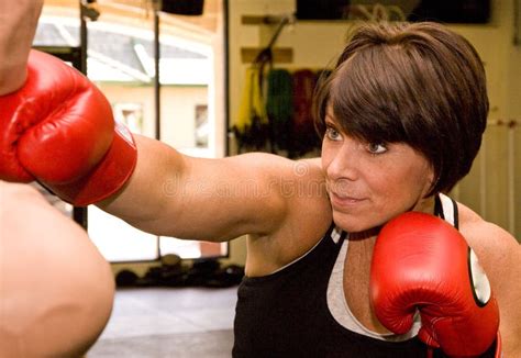 Mature Woman with Boxing Dummy Stock Photo - Image of outstretched, exercise: 5757926