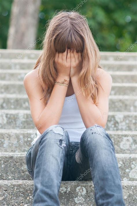 Sad teenage girl sitting alone on the stairs in summer — Stock Photo © SolidPhotos #82929780