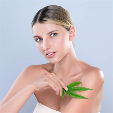 Premium Photo | Alluring beautiful woman portrait hold green leaf as cannabis skincare concept