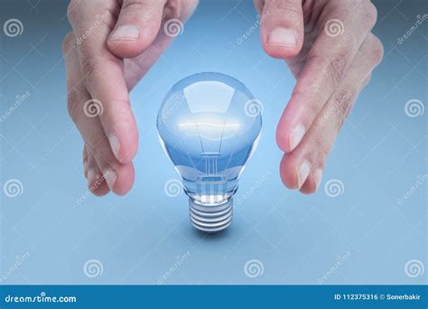 Hand and Energy Saving Lamp on a Blue Background Stock Photo - Image of compact, illuminate ...