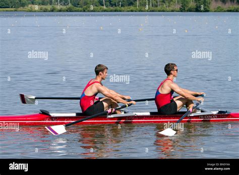 Two man racing shell boat with crew rowing Stock Photo - Alamy