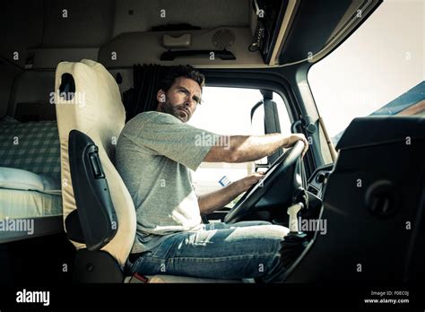 Truck driver with tractor trailer truck Stock Photo - Alamy