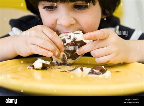 Little boy eating messy ice cream bar Stock Photo - Alamy