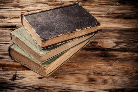 Old books on wooden table Stock Photo by ©jag_cz 54615603