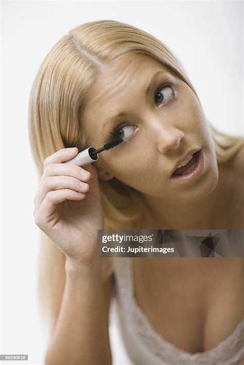 Woman Applying Mascara High-Res Stock Photo - Getty Images