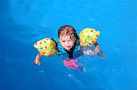 Baby girl in swimming pool stock photo. Image of sunny - 2965142