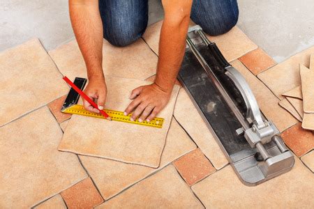 Installing ceramic floor tiles - measuring and cutting the pieces ...
