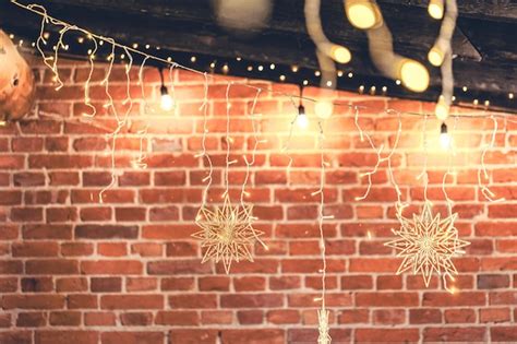 Free Photo | Lights garlands hanging from brick wall at evening christmas house decoration