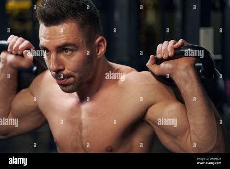 Strong sporty male person lifting heavy weights Stock Photo - Alamy