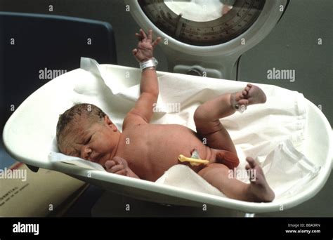 Newly born baby boy on the scales Stock Photo - Alamy