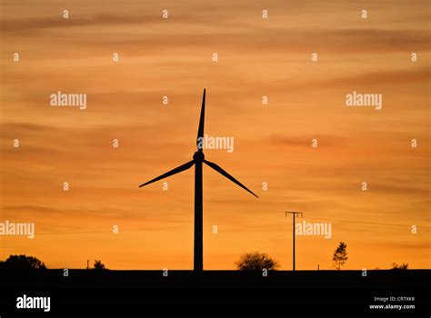 Wind turbine at sunset Stock Photo - Alamy