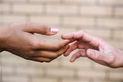 "Black And White Holding Hands" by Stocksy Contributor "Simone Wave" - Stocksy