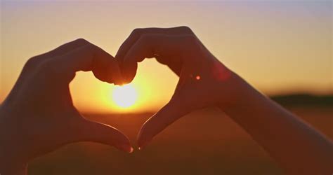 Ocean Sunset Shining Through Heart Shaped Hands Stock Footage Video 6970264 - Shutterstock