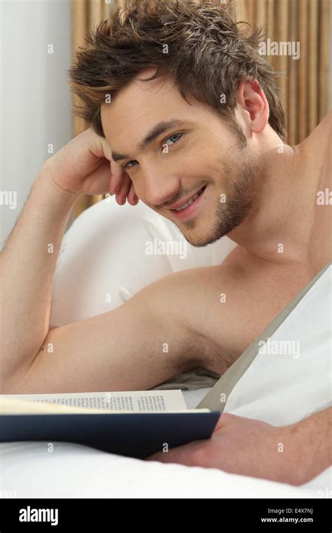 Man reading in bed Stock Photo - Alamy