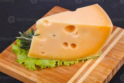 Maasdam cheese in the board served salad leaves 7872074 Stock Photo at Vecteezy