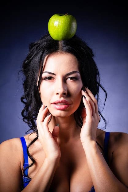 Premium Photo | Halloween a terrible wicked witch holds a poisoned apple in her hands standing ...