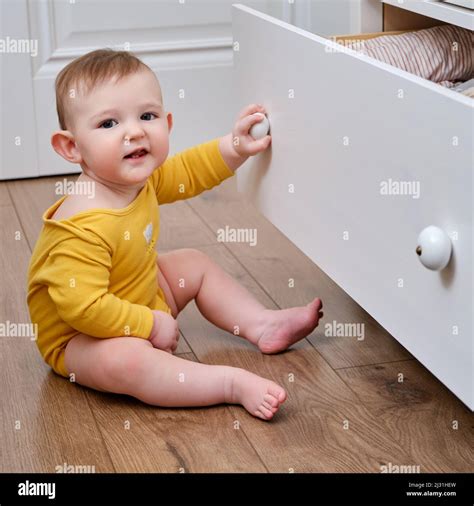 Danger for the baby to pinch the hand of the cabinet door or chest of drawers. Protect children ...
