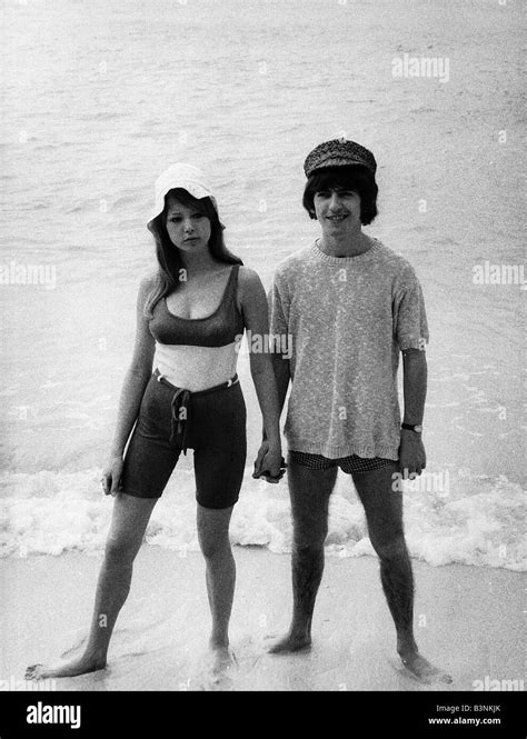 George Harrison of the Beatles with his new wife Patti Boyd on a beach February 1966 Stock Photo ...