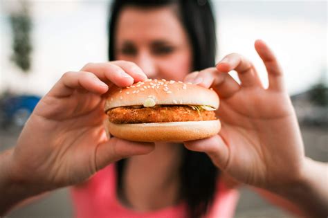 Girl holding Hamburger in her Hands Free Stock Photo | picjumbo