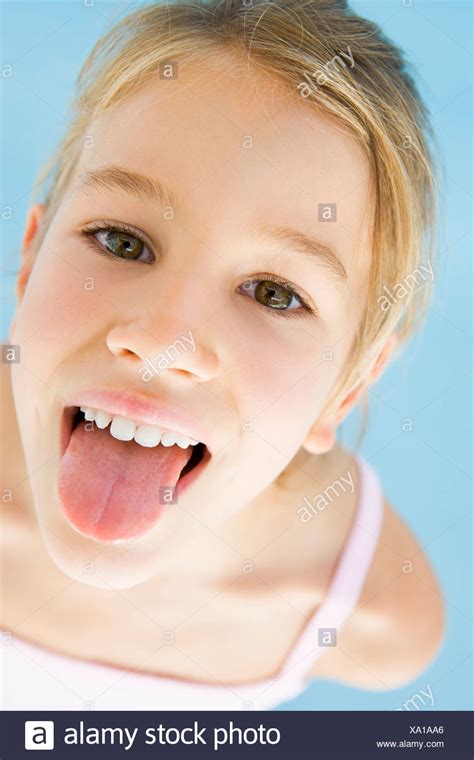 Young girl sticking her tongue out Stock Photo - Alamy