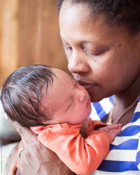 "A Black Mother Holding Her Biracial Newborn Baby Lovingly" by Stocksy Contributor "Anya Brewley ...