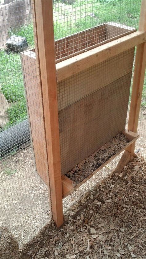 a chicken coop with wood and wire around it