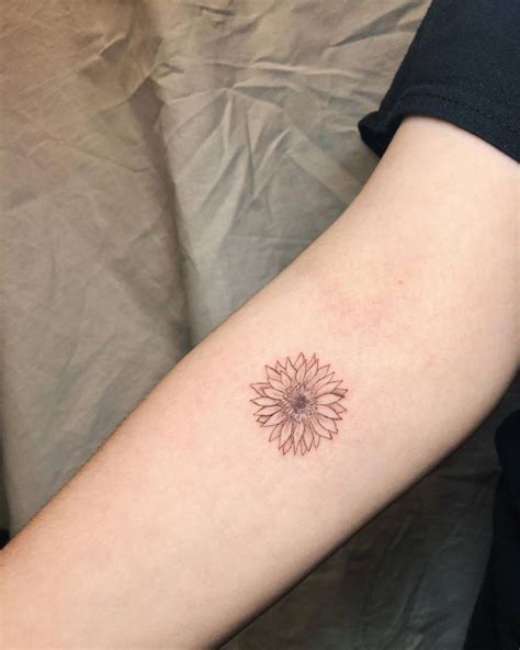 Beautiful sunflower tattoo in fine line tattooed on the