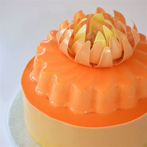 Top tier is coconut sponge cake layered with mango mousse and chocolate glaze. Second tier is ...