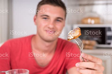 Portrait Of Young Man With Food On Fork Stock Photo - Download Image ...